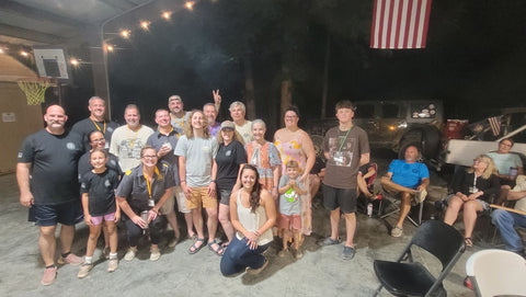 Members of the Jeep community gathering together beneath an American flag